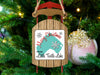Sled ornament with "Merry Christmas from Little Turtle Lake" text against a Christmas tree.