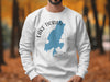 White sweatshirt with blue Lake Tiorati map and compass graphic.