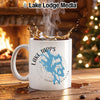 White mug with Lake Tapps Washington design, steam, and fireplace.