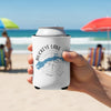 White koozie with Buckeye Lake map and compass on a beach.