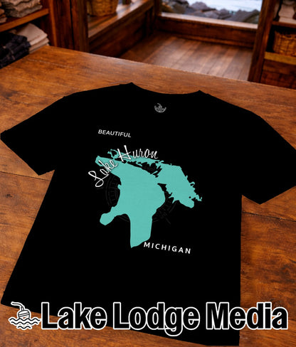 Black t-shirt with teal Lake Huron map and "Lake Lodge Media" logo.