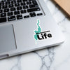 Turquoise silhouette reads "Bomoseen Life" sticker on a laptop.
