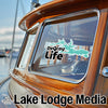 DeGray Life sticker on a wooden boat window, with "Lake Lodge Media" text.