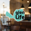 Teal sticker shaped like a lake with black text reading "glen LIFE" and "Lake Lodge Media LLC".