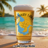 Beer glass with "Roadway Lake" and blue lake shape on a beach