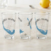 Three clear glasses featuring "Sanibel Island" text, a compass, and Florida map graphic.