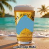 Glass of beer with "Turtle Lake" text and blue Minnesota shape on beach with palm trees.