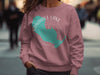 Rose pink crewneck sweatshirt with Sandhill Lake Wisconsin map and compass graphic.