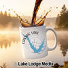 White mug with Castaic Lake map and compass, coffee splashing into it.