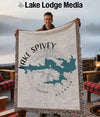 Man holding Lake Spivey, Georgia map blanket with compass detail and fringed edges.