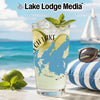 Glass with drink, lime slices, mint, and lake map design on beach background.