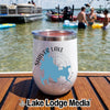 A white insulated tumbler with a Shaver Lake graphic rests on a wooden boat deck.