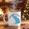 White mug with Lake Lawtonka map and compass design, with coffee splash.