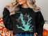 Black sweatshirt with turquoise map of Louisville Lake, Texas and compass rose.
