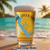 Glass of beer with Cedar Creek Lakes map and compass on a beach background.