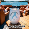 A white stainless steel tumbler rests on a wooden boat table, featuring a Lakewood Lakes Missouri graphic.