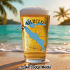 Glass of beer on beach with "Lake Merced" logo and compass.