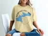 Yellow t-shirt with "Merrymeeting Lake New Hampshire" text and blue lake shape graphic.