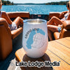 A white stemless wine tumbler with a Grand Lake Colorado map and compass design sits on a wooden boat table.