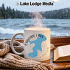 White mug with blue Canobie Lake map and compass design on wooden table.