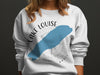 White sweatshirt with Lake Louise map, compass, and "Banff" text.