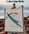 Man holding a Lacamas Lake Washington throw blanket with a compass and map design.