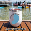 A white insulated tumbler with a Newnans Lake map graphic sits on a wooden boat deck.