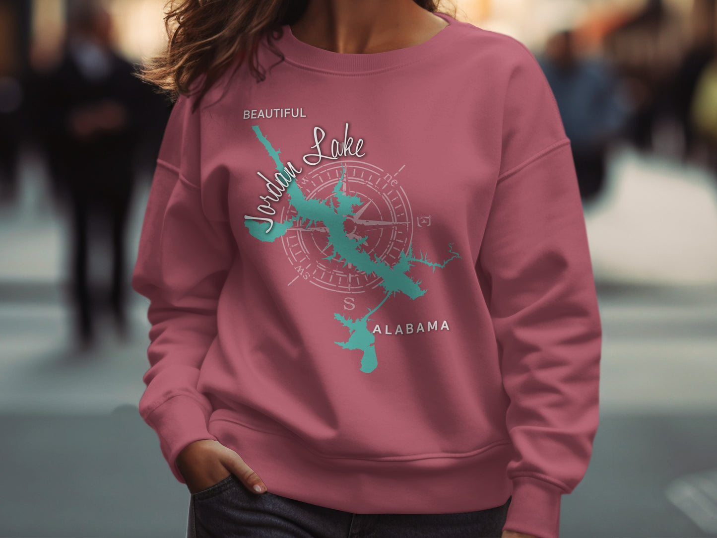 Pink sweatshirt with Jordan Lake Alabama map and compass design.