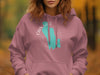 Pink hoodie with a teal map graphic and text reading "Cain Lake Washington"