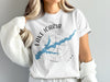 White t-shirt with Lake Icaria Iowa design and compass graphic.