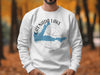 White sweatshirt with Grenada Lake, Mississippi map and compass graphic.