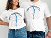 White t-shirts with "Lake Windermere England" and compass design.