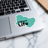 Turquoise sticker on a laptop keyboard, reads "Calhoun Life".