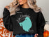 Black sweatshirt with teal Lake Okeechobee map and compass rose.