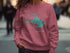 Pink sweatshirt with "Lake Rampart Colorado" and compass design.
