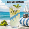 Glass of lemonade with lime and mint on a beach, with "Lake Lodge Media" logo.