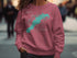 Teal map of Lake Marble Falls, Texas on a pink sweatshirt.