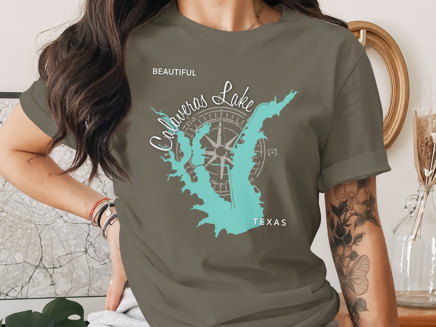 Olive green t-shirt with Calaveras Lake Texas map and compass rose graphic.