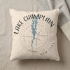 Light colored pillow with Lake Champlain map and compass rose graphic.