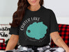 Crater Lake Oregon graphic with compass rose on black t-shirt.