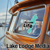 "Barlow Life" logo sticker on a wooden boat window, with "Lake Lodge Media" text below.