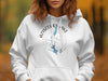 White hoodie with Aziscoos Lake Maine compass graphic in blue.