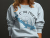 Light blue sweatshirt with blue lake map and compass graphic and text.