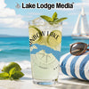Glass of lemonade with lime and mint, compass design, beach background.