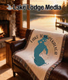 Cream blanket with teal Tohopekaliga map and compass rose on a couch.