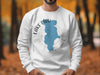 White sweatshirt with the silhouette of Lake Piru, California, and compass design.