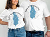 White t-shirts with blue Lake Derwentwater map and compass design.