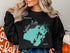 Black sweatshirt with teal Indian Lake map and "OHIO" text.