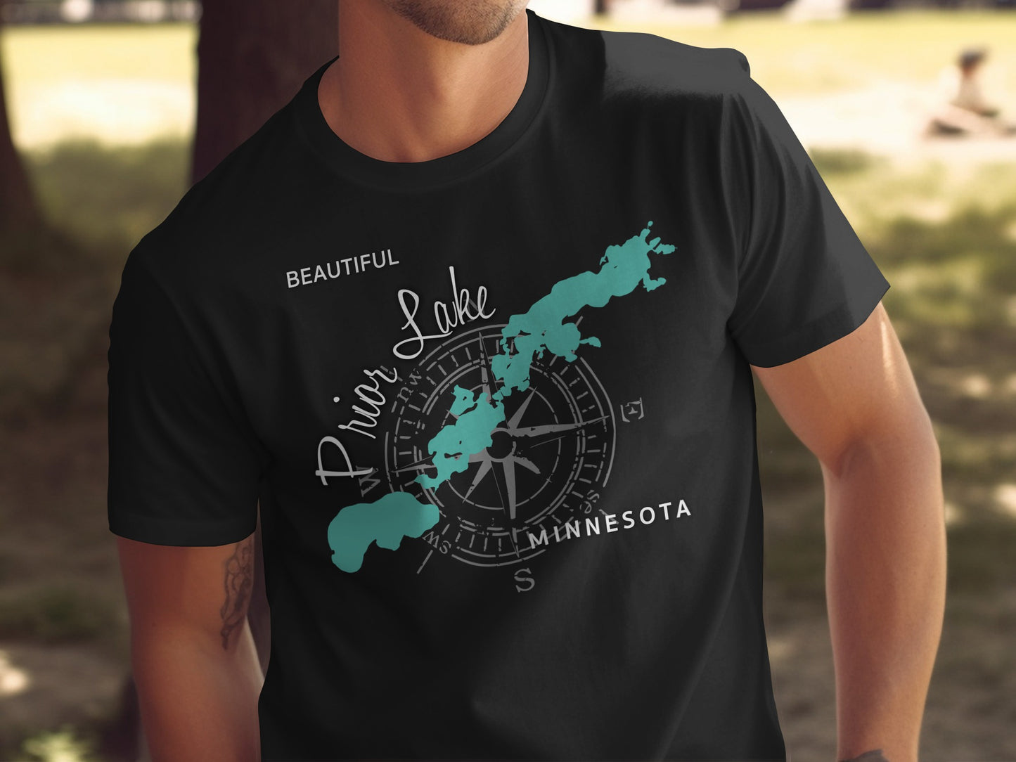 Black t-shirt with a teal map of Prior Lake and a compass graphic.