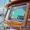Teal Crater Life sticker on a wooden boat window; Lake Lodge Media logo.